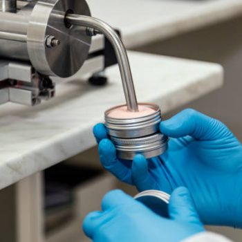 Close up of human hands working at cosmetic factory, medical products